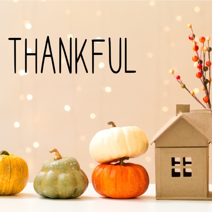 thankful-message-with-pumpkins-with-a-house-picture-id1173881410.jpg
